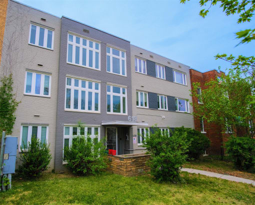 a large building with a sidewalk in front of it