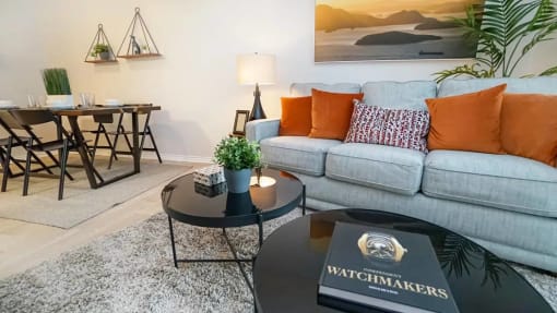 a living room with a couch and a table at Elevate at Huebner Grove, Texas