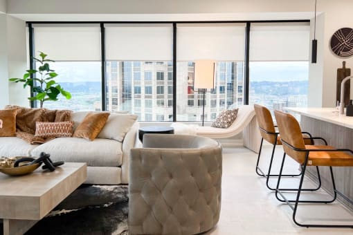 a living room with a couch and chairs and a city view at The 600 Apartments, Birmingham, AL 35203
