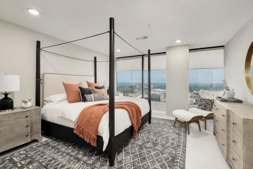 a bedroom with a large bed and a large window at The 600 Apartments, Birmingham