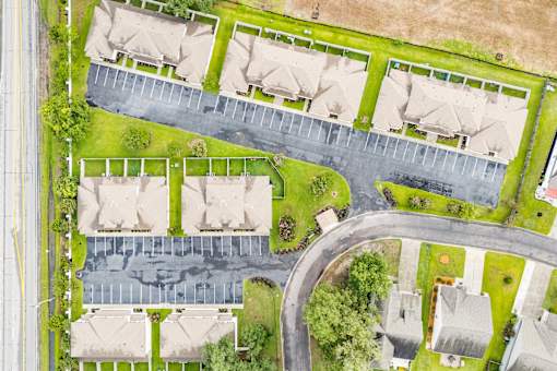 A residential area with houses and a parking lot.