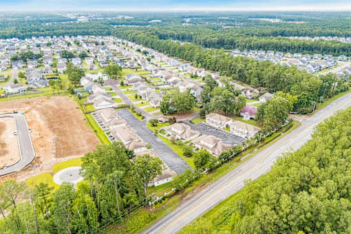 A bird's eye view of a residential area with houses and roads.