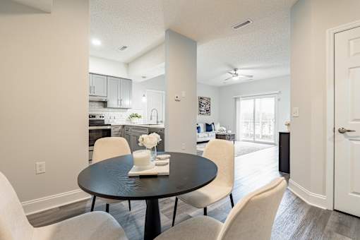 A dining room with a table set for two.