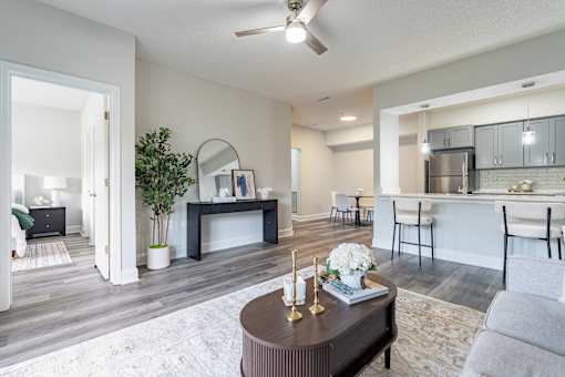 A modern living room with a brown coffee table in the center.