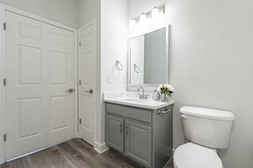 A white toilet sits next to a sink in a bathroom.