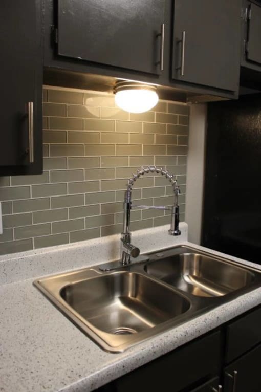 a sink with a faucet in a kitchen at Elevate at Huebner Grove, San Antonio