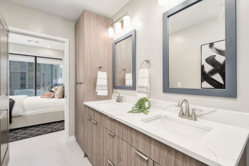 a bathroom with a sink and a mirror at The 600 Apartments, Birmingham, AL