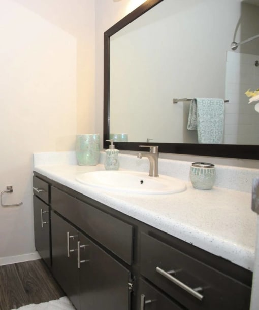 a bathroom with a sink and a mirror at Elevate at Huebner Grove, Texas, 78230