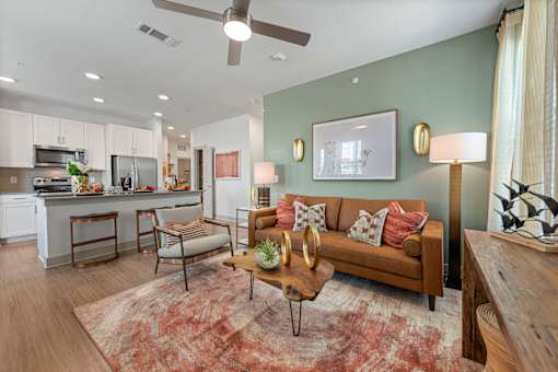 A living room with a brown couch, a coffee table, and a rug.