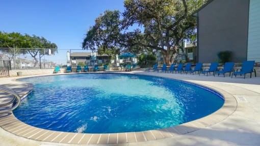 a large swimming pool with a fence around it at Elevate at Huebner Grove, San Antonio, TX 78230
