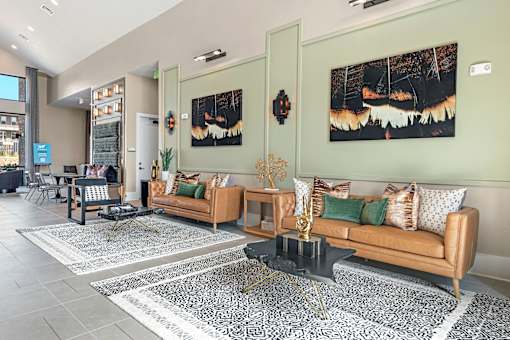 A living room with a couch, coffee table, and two paintings on the wall.