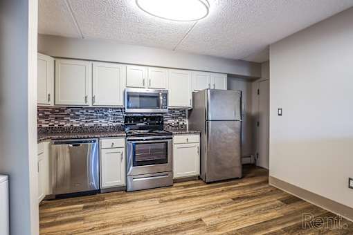 Kitchen with stainless steel appliances and wooden floors at Summit Terrace, South Portland, ME