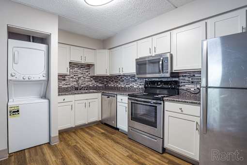 Kitchen with white appliances and wooden floors at Summit Terrace, South Portland, 4106