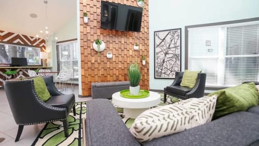 a living room filled with furniture and a flat screen tv at Elevate at Huebner Grove, Texas