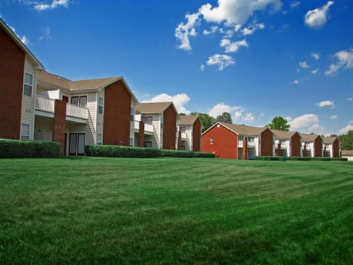 a green lawn in front of an apartment complex at Chester Village Green Apartments, Virginia, 23831