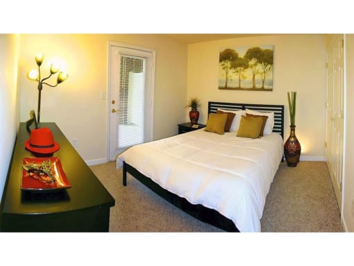 a bedroom with a bed and a night stand at Chesterfieldfield Garden Apartments, Chesterfield, VA, 23836