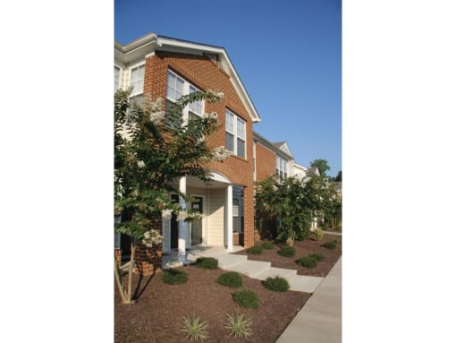 a house with a walkway and trees in front of it at Chesterfieldfield Garden Apartments, Virginia