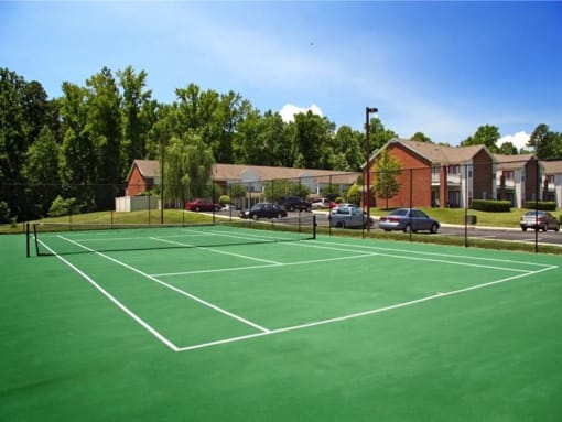 a tennis court in front of a building at Chesterfieldfield Garden Apartments, Chesterfield, 23836