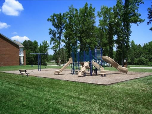 a playground with two slides and a swing set at Chesterfieldfield Garden Apartments, Chesterfield, 23836