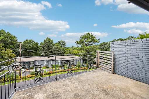 A house with a driveway and a fence.