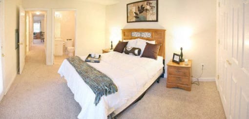a bedroom with a bed and a night stand at Chester Village Green Apartments, Virginia, 23831
