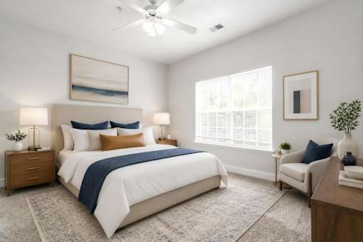 A bedroom with a large bed and a ceiling fan.