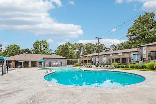 A large swimming pool in the middle of a parking lot.