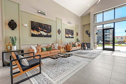 A living room with a couch, chair, and a rug.