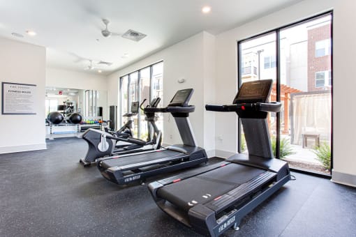 the gym at the flats at obsidian tower has treadmills and exercise equipment