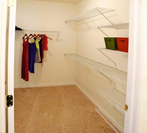 a walk in closet with shelves and clothes at Chester Village Green Apartments, Chester, VA, 23831