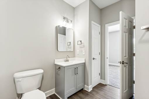A white toilet sits next to a sink in a bathroom.