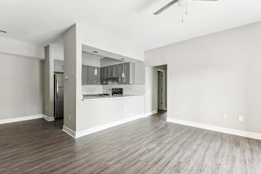 A spacious kitchen with a refrigerator, cabinets, and a countertop is visible.
