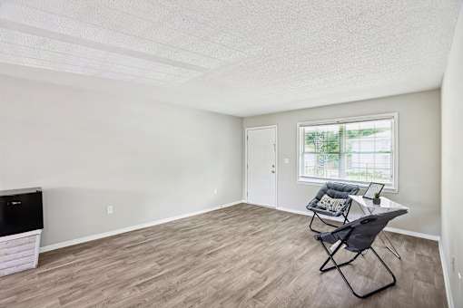 A room with a desk and chair in it.