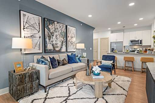 A modern living room with a white couch and a coffee table.