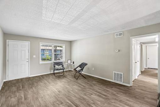 A room with a chair and a window.