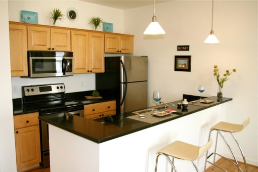 a kitchen with a counter top and a refrigerator at Chester Village Green Apartments, Virginia, 23831