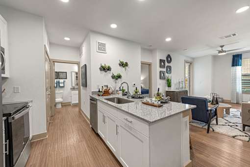 A modern kitchen with a large island and a dining area.