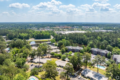 an aerial view of a park with buildings and trees