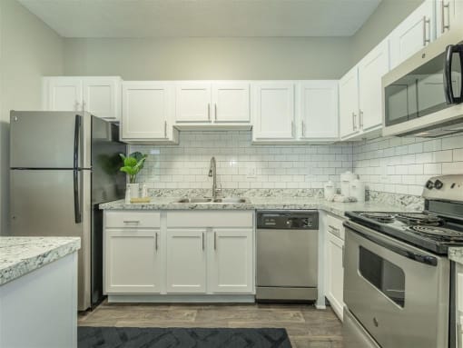 a renovated kitchen with white cabinets  at Avenues of Kennesaw East & West, Kennesaw, 30144