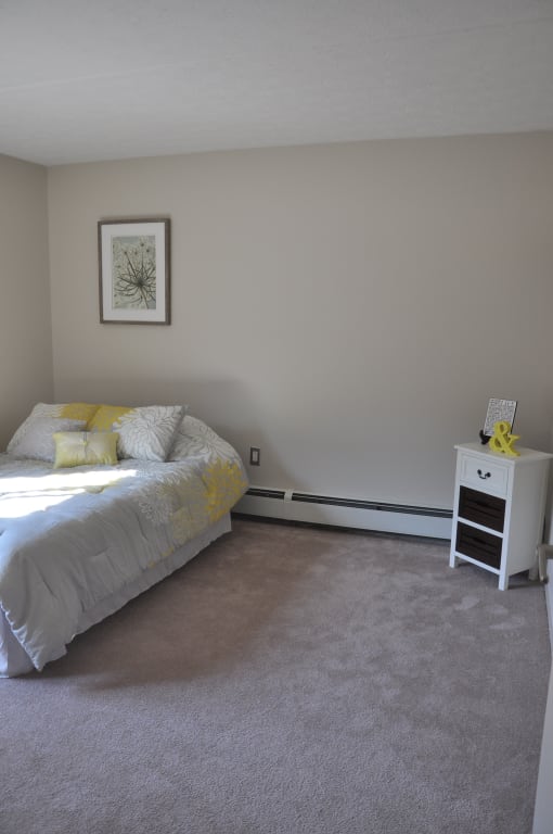 Bedroom with cozy bed and table at Summit Terrace Apartment, South Portland, ME