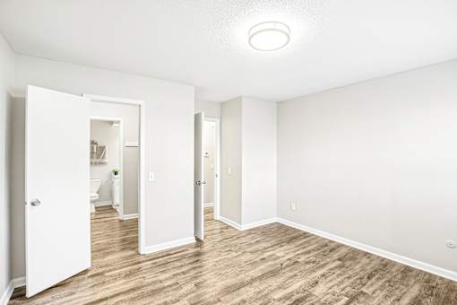 A white room with a doorway leading to another room.