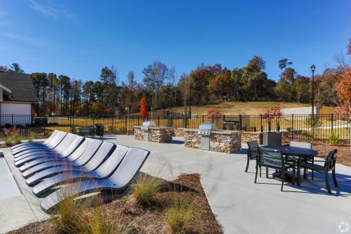 the outdoor patio at the whispering winds apartments in pearland, tx