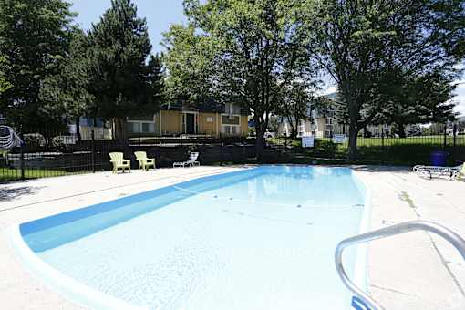 A small pool with a metal railing around it.