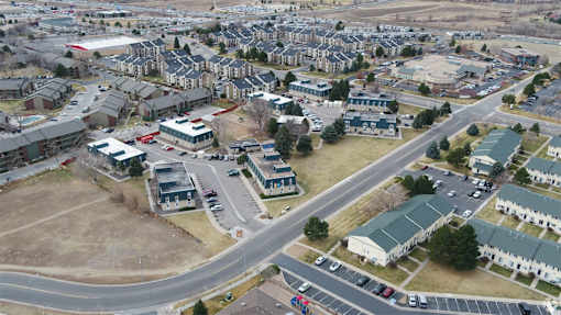 A bird's eye view of a residential area with houses and roads.