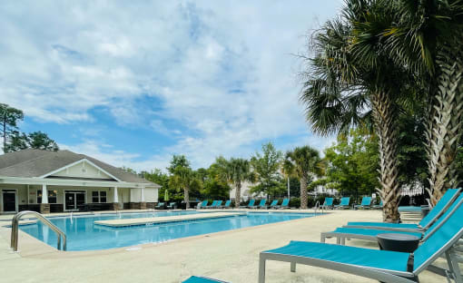 Beautiful pool with loungers at Oasis at Cedar Branch in Wilmington, NC