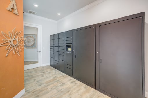 a set of stainless steel storage lockers in a room with a hallway and a