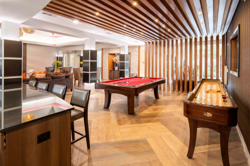 a game room with a pool table and a billiard table