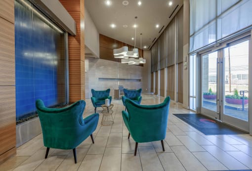 a lobby with blue chairs and large windows