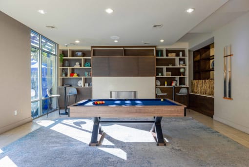 a game room with a pool table and a fireplace