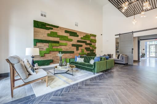 a living room with a green couch and a brick wall with moss on it